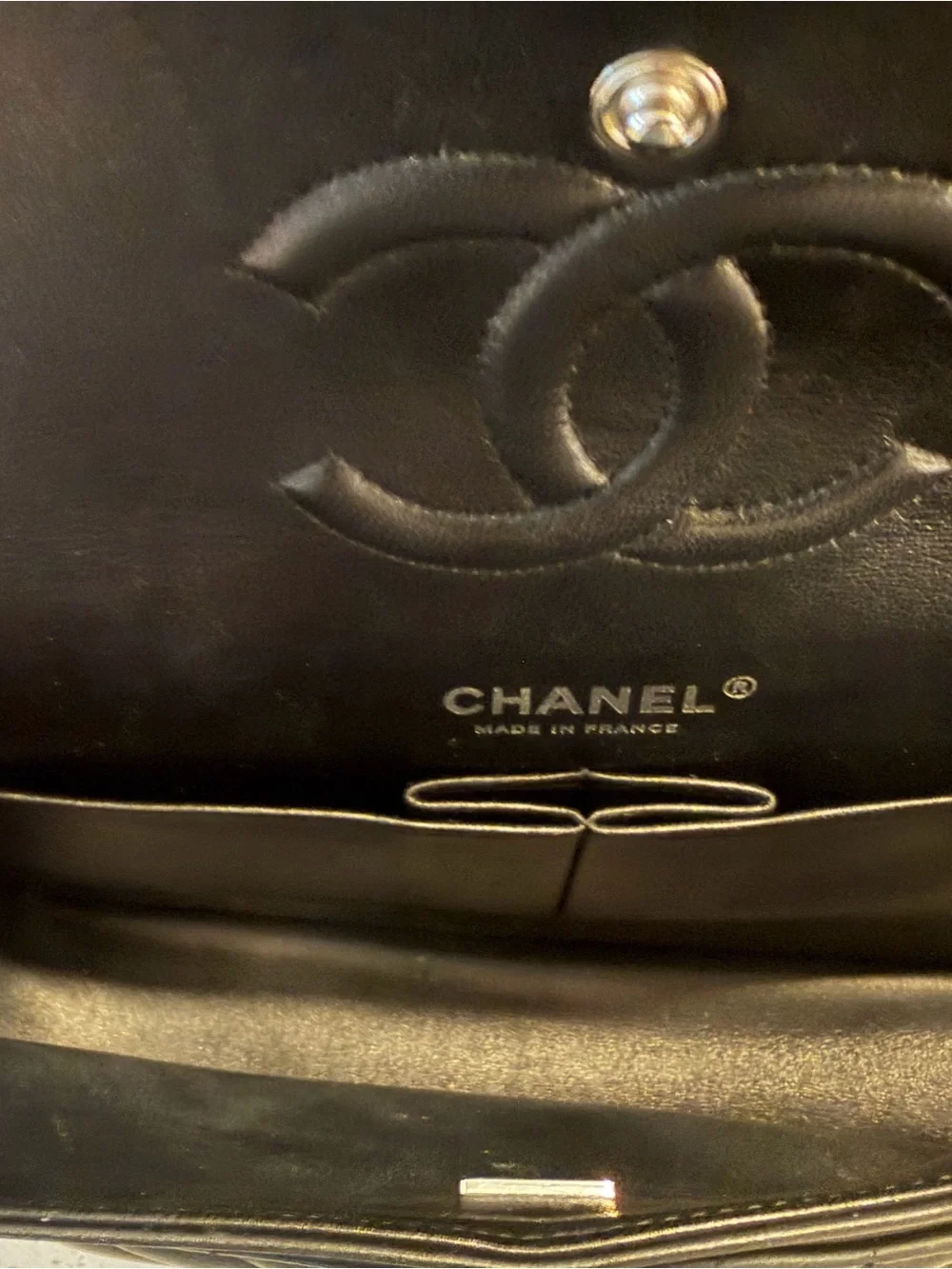 CHANEL Black Leather Interior with Silver Logo Plaque
